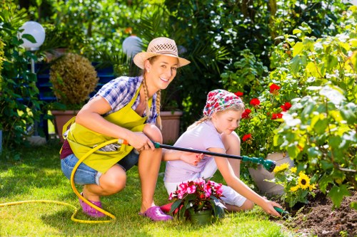 Gardener demonstrating inclusive gardening techniques in a Stratford yard