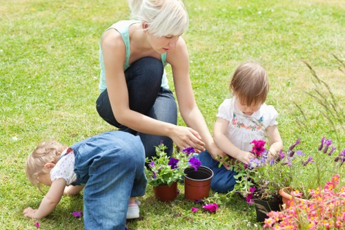 Gardener assessing a garden with clipboard and safety gear